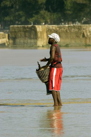  A local youth drumming on the beach at Tofo,  